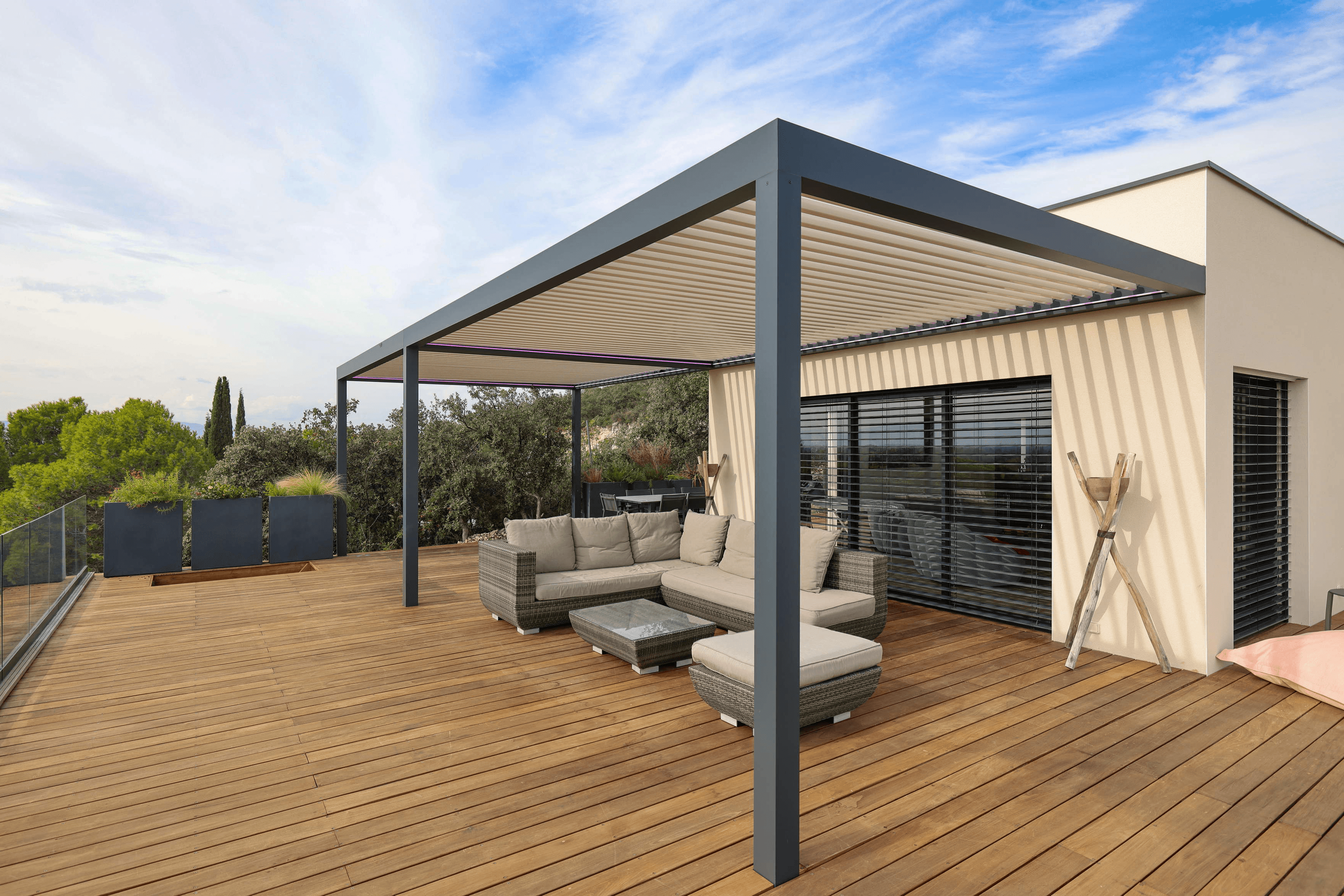 Biossun double-bay bioclimatic pergola with adjustable slats on wooden terrace