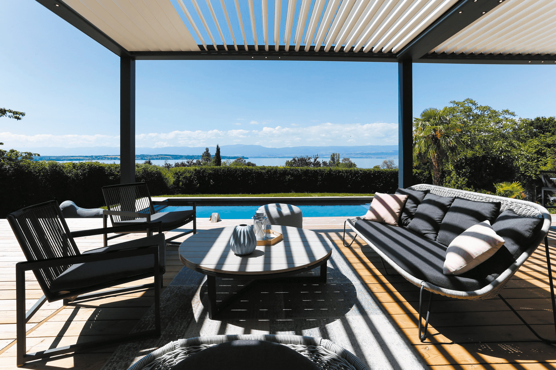 Biossun bioclimatic pergola from below with shades and garden furniture
