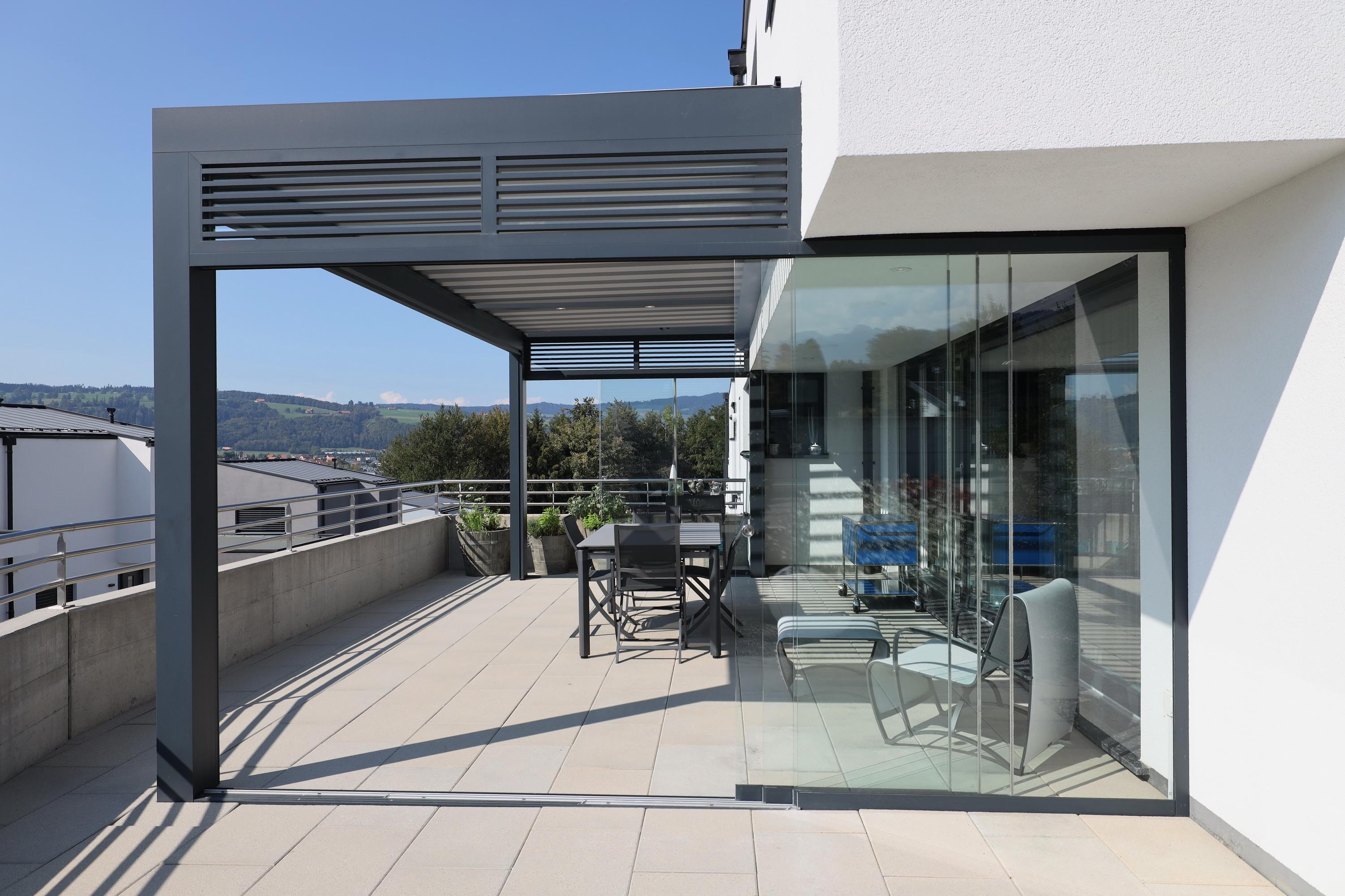 Original Biossun bioclimatic pergola on apartment terrace with glazing 